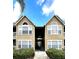 Building exterior with well-maintained landscaping showing the walkway to the units at 1057 S Hiawassee Rd # 1913, Orlando, FL 32835