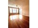 Bright living room boasts sleek hardwood floors, a ceiling fan, and a sliding glass door for ample natural light at 1057 S Hiawassee Rd # 1913, Orlando, FL 32835