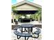Covered outdoor kitchen offers grill, sink, countertop, and picnic table perfect for entertaining at 1057 S Hiawassee Rd # 1913, Orlando, FL 32835
