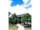 Community outdoor kitchen with several grills and picnic tables surrounded by palm trees at 1057 S Hiawassee Rd # 1913, Orlando, FL 32835
