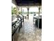 Outdoor kitchen with grill, sink, and countertop overlooks a serene lake, creating an inviting space at 1057 S Hiawassee Rd # 1913, Orlando, FL 32835