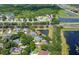 Beautiful aerial view of a suburban home with a screened pool, lush landscaping, and pond frontage at 13108 Lakeshore Grove Dr, Winter Garden, FL 34787