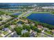 Aerial view of the single-story home with screened in lanai, pond and lake view and highways nearby at 13108 Lakeshore Grove Dr, Winter Garden, FL 34787