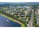 Aerial view of the single-story home with screened in lanai, pond and lake view in community at 13108 Lakeshore Grove Dr, Winter Garden, FL 34787
