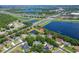 Aerial view of the single-story home with screened in lanai and pond view in community at 13108 Lakeshore Grove Dr, Winter Garden, FL 34787