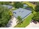 Aerial view of the single-story home with screened in lanai, well-manicured lawn, and beautiful landscaping at 13108 Lakeshore Grove Dr, Winter Garden, FL 34787