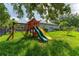Spacious backyard featuring a wooden playset with slides, swings and plenty of room to play at 13108 Lakeshore Grove Dr, Winter Garden, FL 34787