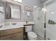 Elegant bathroom featuring a glass-enclosed shower, a modern vanity, and contemporary fixtures at 13108 Lakeshore Grove Dr, Winter Garden, FL 34787