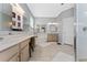 This large bathroom features a large vanity, large mirrors, garden tub, and step-in shower at 13108 Lakeshore Grove Dr, Winter Garden, FL 34787
