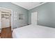 This is a calming bedroom with light blue walls, hardwood floors, and a closet at 13108 Lakeshore Grove Dr, Winter Garden, FL 34787