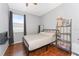 Cozy bedroom featuring wood floors, natural light, and a comfortable bed at 13108 Lakeshore Grove Dr, Winter Garden, FL 34787