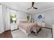 This is a primary bedroom filled with natural light, a ceiling fan, and neutral tones at 13108 Lakeshore Grove Dr, Winter Garden, FL 34787