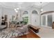 Bright foyer featuring high ceilings, arched windows, and a combination of tile and wood flooring at 13108 Lakeshore Grove Dr, Winter Garden, FL 34787