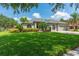 Charming single-story home featuring a well-manicured lawn, beautiful landscaping, and a two-car garage at 13108 Lakeshore Grove Dr, Winter Garden, FL 34787