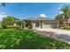 Charming single-story home featuring a well-manicured lawn, beautiful landscaping, and a two-car garage at 13108 Lakeshore Grove Dr, Winter Garden, FL 34787