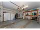 Spacious garage featuring storage cabinets, ceiling fan, and ample room for parking and storage at 13108 Lakeshore Grove Dr, Winter Garden, FL 34787