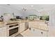 Bright kitchen featuring granite countertops, white cabinets, and an island with ample counter space at 13108 Lakeshore Grove Dr, Winter Garden, FL 34787