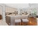 Open kitchen with granite countertops, breakfast bar, and modern stainless steel appliances at 13108 Lakeshore Grove Dr, Winter Garden, FL 34787