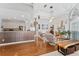 Open-concept living room with hardwood floors, modern decor, and seamless flow to the kitchen at 13108 Lakeshore Grove Dr, Winter Garden, FL 34787
