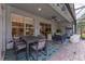Screened-in patio features an outdoor dining area and additional seating with a ceiling fan and manicured landscaping at 13108 Lakeshore Grove Dr, Winter Garden, FL 34787