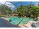 Beautiful screened-in pool surrounded by lush landscaping and a brick-paved patio at 13108 Lakeshore Grove Dr, Winter Garden, FL 34787
