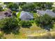 An aerial view of the rear of a house with solar panels, a screen enclosed patio, and a view of a pond at 13108 Lakeshore Grove Dr, Winter Garden, FL 34787