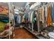This is a walk-in closet with plenty of hanging and storage space, and a small stool at 13108 Lakeshore Grove Dr, Winter Garden, FL 34787