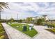 Inviting community lawn with lounge seating, games, well-manicured landscaping and nearby residential buildings at 1454 Pinecliff Dr, Apopka, FL 32703