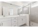 Elegant bathroom featuring a double vanity, a large mirror, and a glass-enclosed shower at 150 Fredericksburg Ave, Orange City, FL 32763