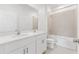 Bright bathroom featuring a double vanity with modern fixtures and a tiled shower at 150 Fredericksburg Ave, Orange City, FL 32763