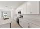 Modern kitchen featuring white cabinets, stainless steel appliances, and quartz countertops at 150 Fredericksburg Ave, Orange City, FL 32763
