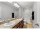 Bathroom features double sinks, large mirror and shower/tub combo with fun polka dot shower curtain at 15058 Sawgrass Bluff Dr, Winter Garden, FL 34787