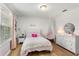 Bedroom featuring light pink decor, with a cushioned chair and light wood floors at 15058 Sawgrass Bluff Dr, Winter Garden, FL 34787