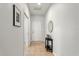 Neutral hallway with tile flooring, features a decorative table adding a personal touch at 15058 Sawgrass Bluff Dr, Winter Garden, FL 34787