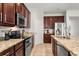 Stylish kitchen with stainless steel appliances, granite countertops, and ample cabinet space at 15058 Sawgrass Bluff Dr, Winter Garden, FL 34787