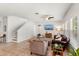 Bright living room with tile flooring, comfortable seating, and a ceiling fan for added comfort at 15058 Sawgrass Bluff Dr, Winter Garden, FL 34787
