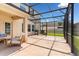 View of the screened in patio with a seating area and barbecue, providing an excellent outdoor living space at 15058 Sawgrass Bluff Dr, Winter Garden, FL 34787