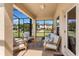 Screened in patio featuring comfortable seating with view of neighborhood at 15058 Sawgrass Bluff Dr, Winter Garden, FL 34787