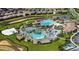 Aerial view of a resort-style community with multiple pools, landscaping, and recreation areas at 1533 Flange Dr, Davenport, FL 33896
