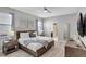 Bright bedroom featuring neutral walls, fan, and bed with wood frame, creating a relaxing and welcoming atmosphere at 1533 Flange Dr, Davenport, FL 33896