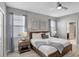 Bright bedroom with hardwood floors, ceiling fan, and comfortable bed, creating a relaxing and stylish retreat at 1533 Flange Dr, Davenport, FL 33896