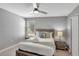 Charming bedroom with gray walls, ceiling fan, and a cozy queen-size bed at 1533 Flange Dr, Davenport, FL 33896