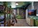 Forest themed bedroom features custom bunk beds, unique decor, and forest wall, creating an immersive experience at 1533 Flange Dr, Davenport, FL 33896