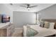 Bedroom featuring a queen bed, grey dresser, and wall-mounted flat screen TV at 1533 Flange Dr, Davenport, FL 33896