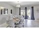 Elegant dining room with a large table, chandelier, and plenty of seating for entertaining at 1533 Flange Dr, Davenport, FL 33896