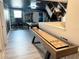 Spacious game room featuring a shuffleboard table, pool table, and custom wall murals at 1533 Flange Dr, Davenport, FL 33896