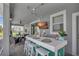 Outdoor bar with white countertop, teal base, TV, string lights, and seating for four at 1533 Flange Dr, Davenport, FL 33896