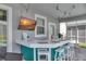 Outdoor bar with white countertop, teal base, TV, string lights, and seating for four at 1533 Flange Dr, Davenport, FL 33896