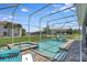 Screened-in pool and spa area with comfortable lounge chairs and a well-maintained backyard at 1533 Flange Dr, Davenport, FL 33896
