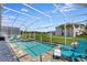 Screened-in pool and spa area with comfortable lounge chairs and a well-maintained backyard at 1533 Flange Dr, Davenport, FL 33896